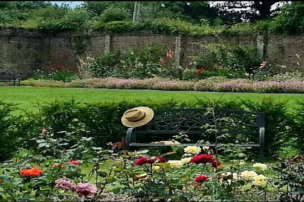 Flower beds in bloom inside the old stone walls of the garden